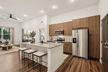 A modern kitchen with a white island and stainless steel appliances